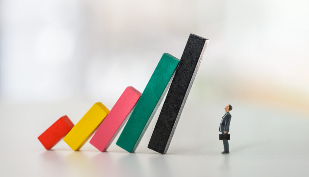 Company financial risk and escape methods, business strategy concept : Businessman CEO looks at collapsed bar graphs in a situation that needs prompt action. Leader / Manager confronts tough problems Company financial risk and escape methods, business strategy concept : Businessman CEO looks at collapsed bar graphs in a situation that needs prompt action. Leader / Manager confronts tough problems