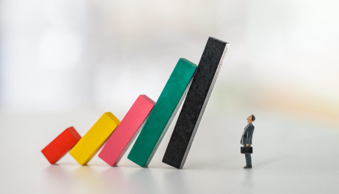 Company financial risk and escape methods, business strategy concept : Businessman CEO looks at collapsed bar graphs in a situation that needs prompt action. Leader / Manager confronts tough problems Company financial risk and escape methods, business strategy concept : Businessman CEO looks at collapsed bar graphs in a situation that needs prompt action. Leader / Manager confronts tough problems